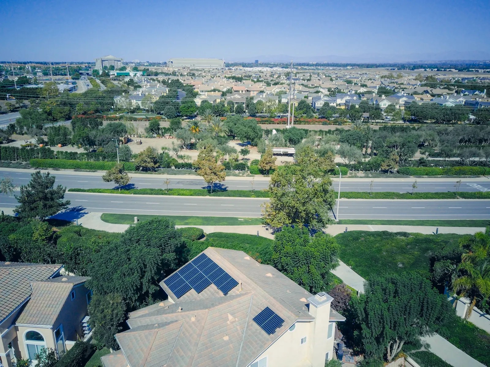 Aerial view of a suburban Texas street with rooftop solar panels on a home