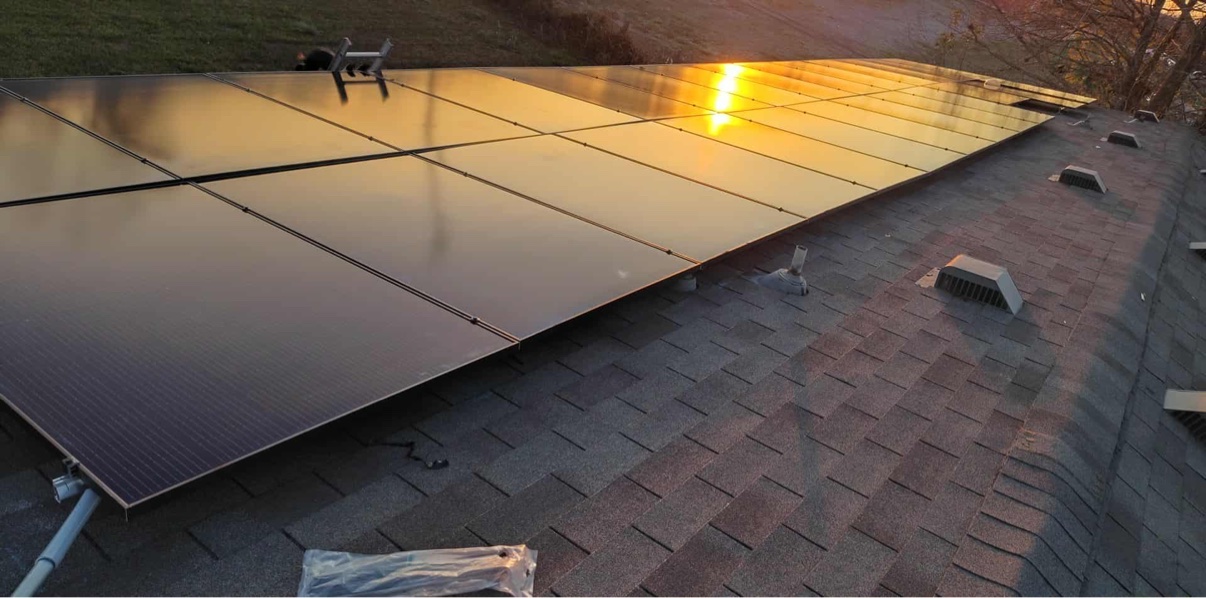 Close-up of solar panels reflecting the setting sun