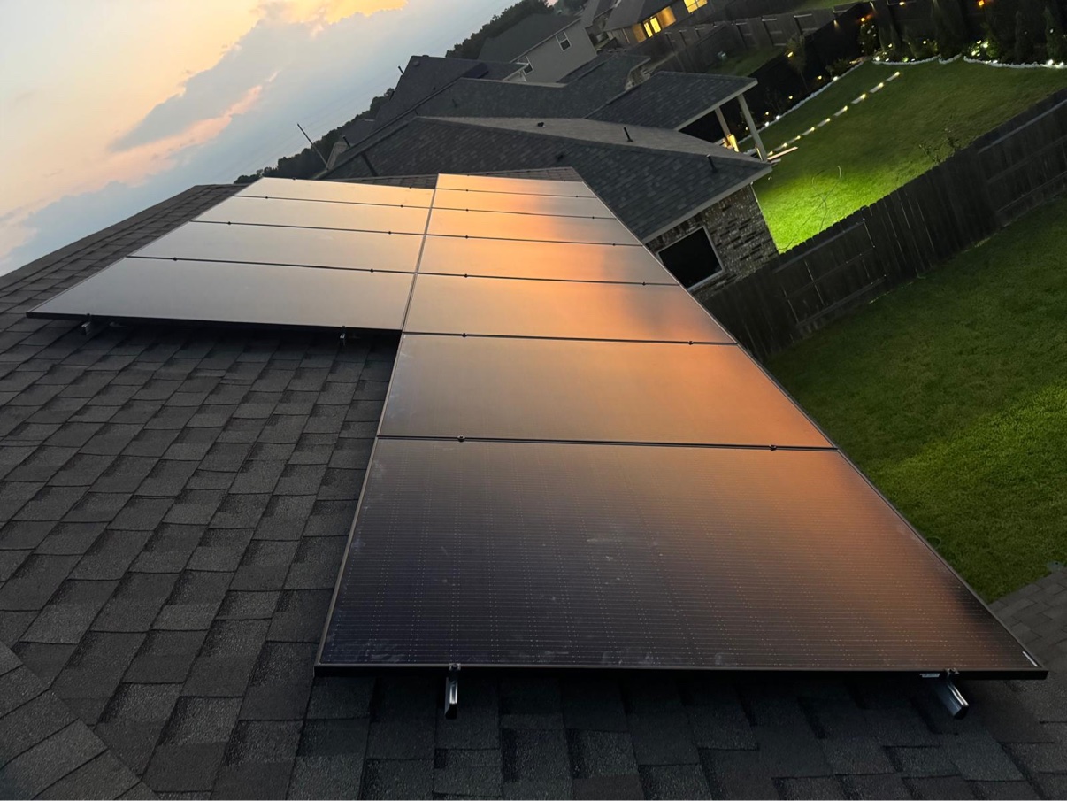 Close-up of solar panels glowing with reflected sunset light