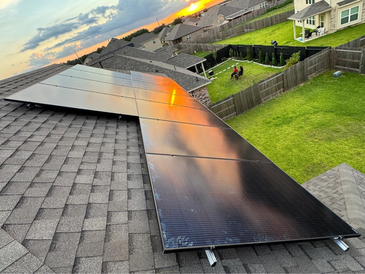 Rooftop view of solar panels reflecting dramatic evening light